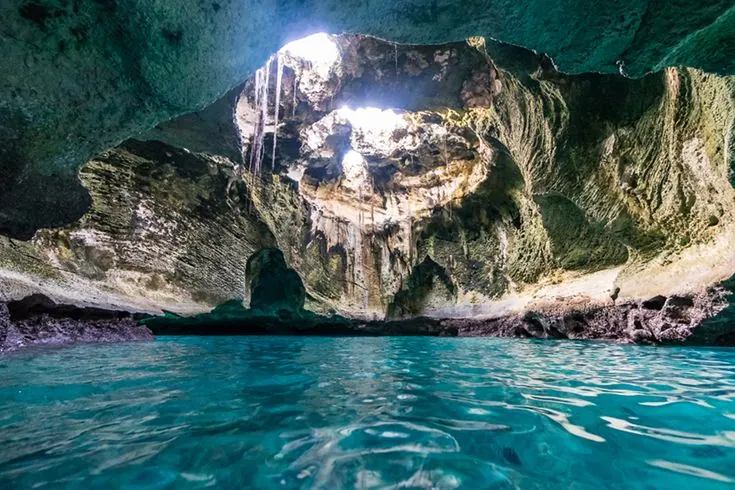 Thunderball Grotto interior — shafts of light through the cave ceiling, Staniel Cay Exuma
